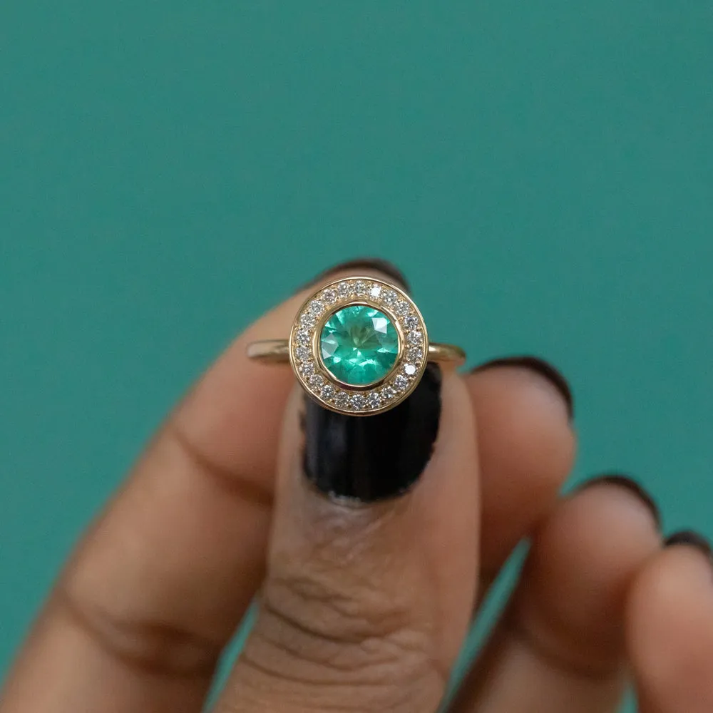 0.94ct Round Neon Green Emerald With Bezel Set Diamond Halo In 18k Yellow Gold