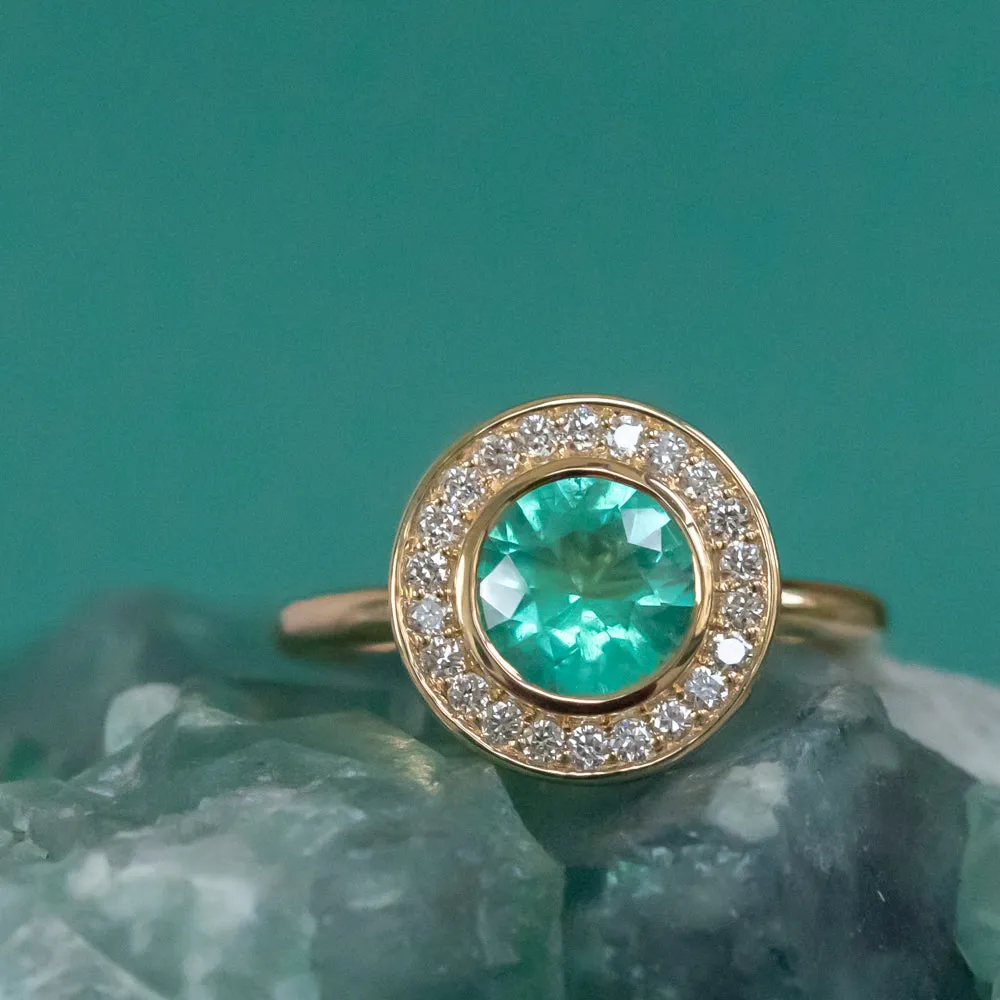 0.94ct Round Neon Green Emerald With Bezel Set Diamond Halo In 18k Yellow Gold