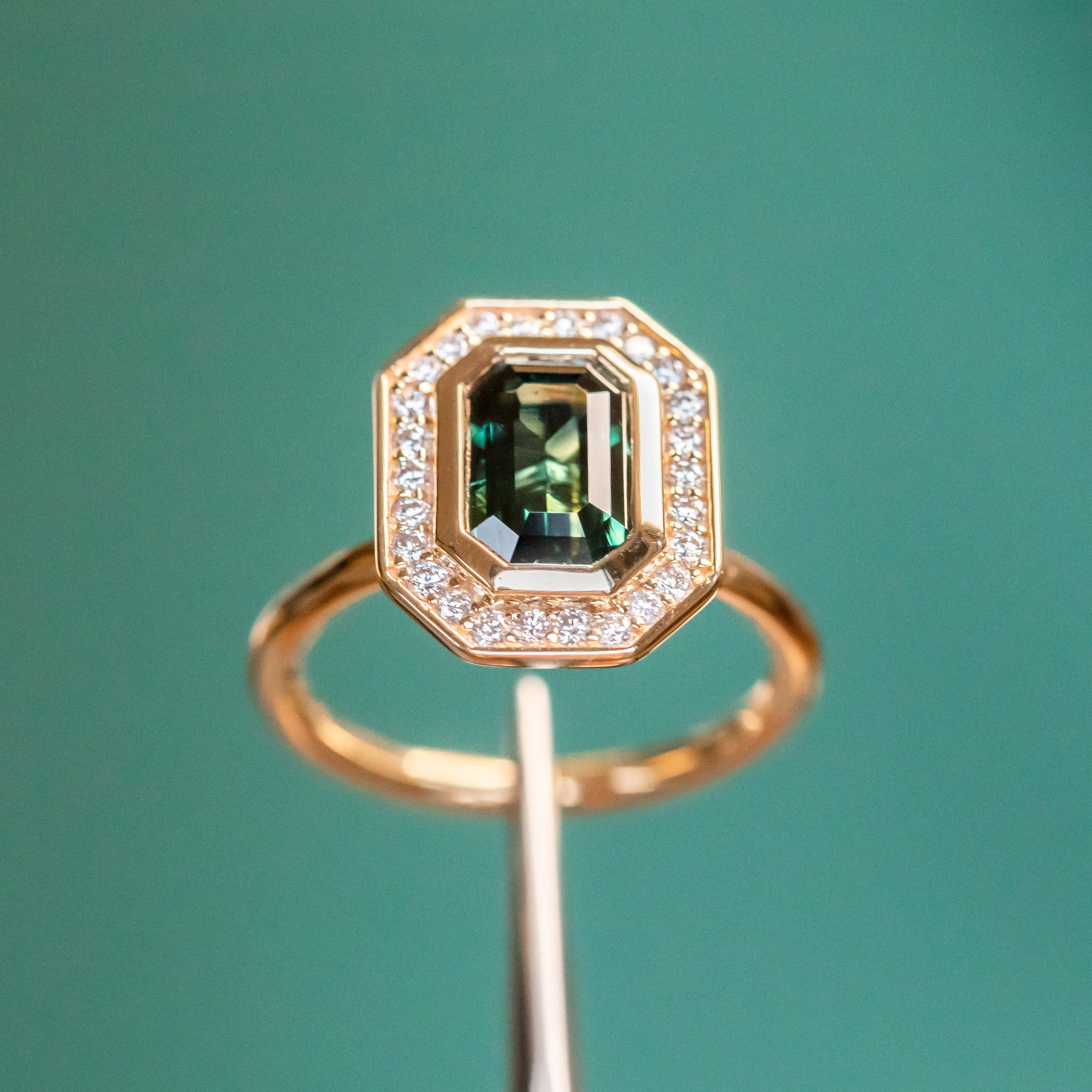 2.05ct Emerald cut Sapphire With Bezel Set Diamond Halo In 14k Yellow Gold