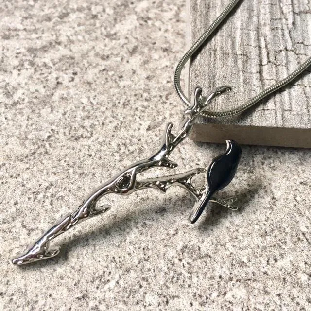 BLACK BIRD-ON-A-BRANCH PENDANT NECKLACE WITH SILVER CHAIN